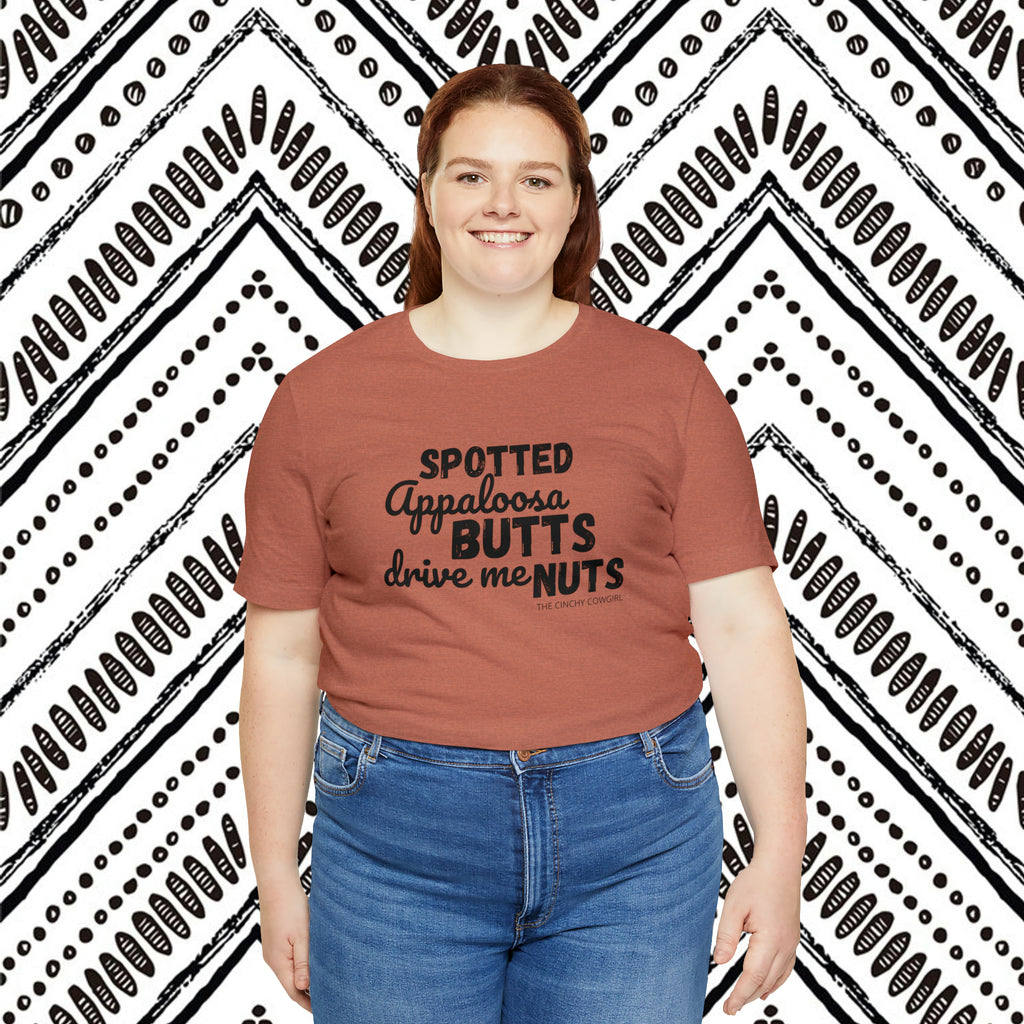 Clay plus size short sleeve with black lettering that reads "Spotted Appaloosa Butts drive me Nuts".