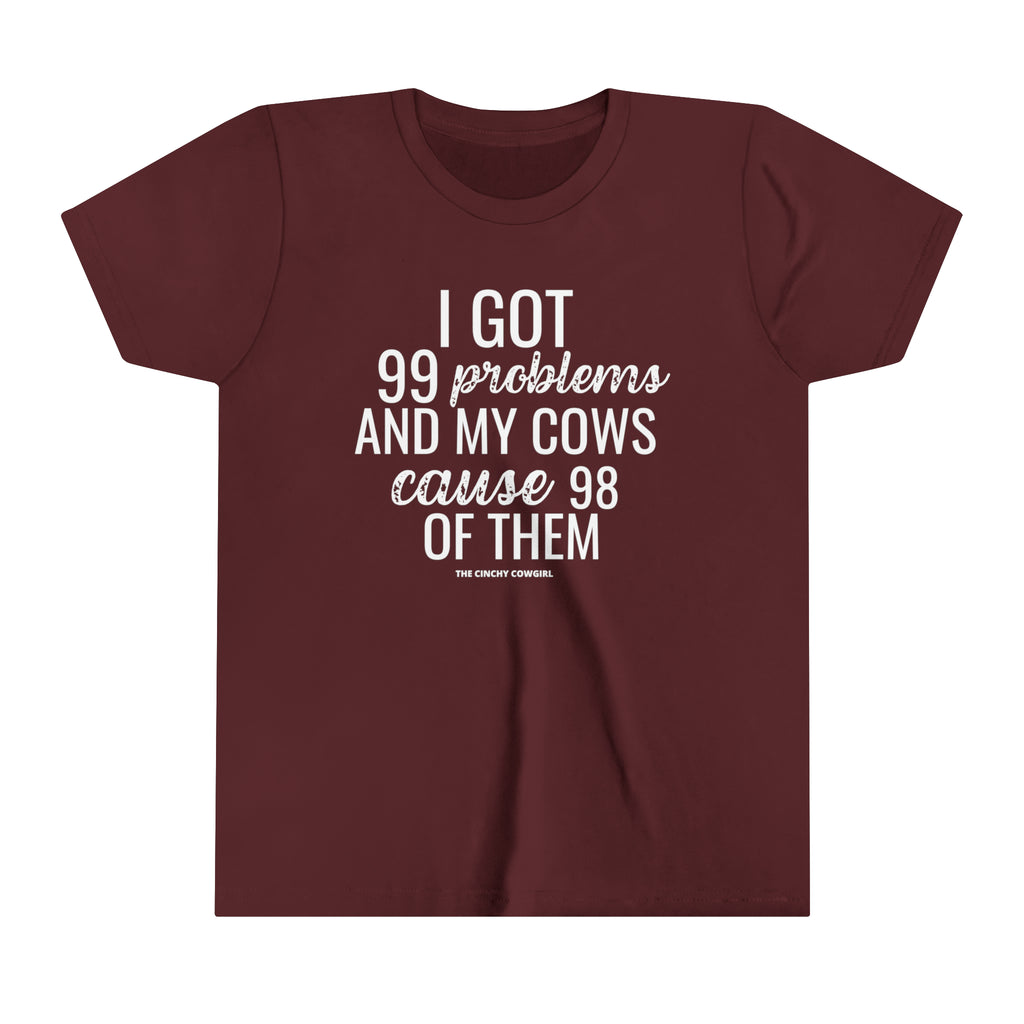 Maroon youth short sleeve tee with white lettering reading "I got 99 problems and my Cows cause 98 of them".