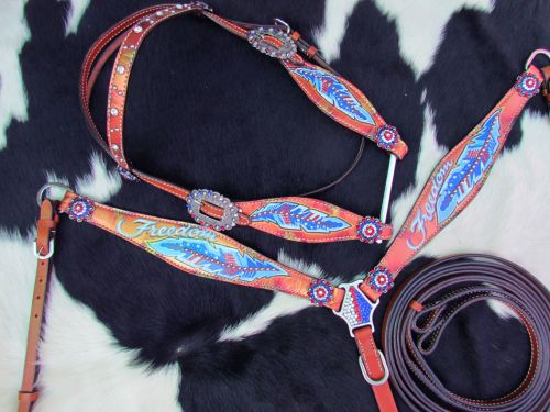 Medium oil headstall set with painted red, white, and blue feather and the word "Freedom" with red, white, and blue conchos accenting the piece. 