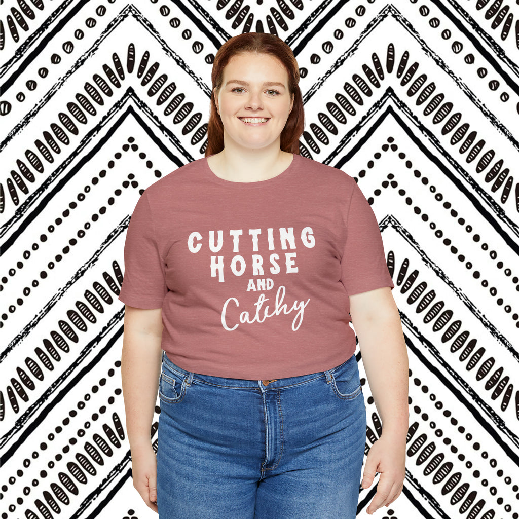 Mauve plus size short sleeve with white lettering reading "Cutting horse and Catchy".