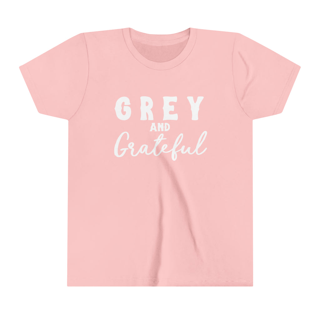 Pink youth short sleeve with white lettering reading "Grey and Grateful". 