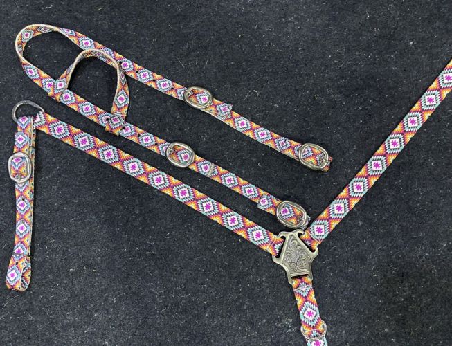 Western nylon headstall set with warm color tribal pattern. Pink, orange and yellow are the predominant color. Brass colored buckles and hardware.