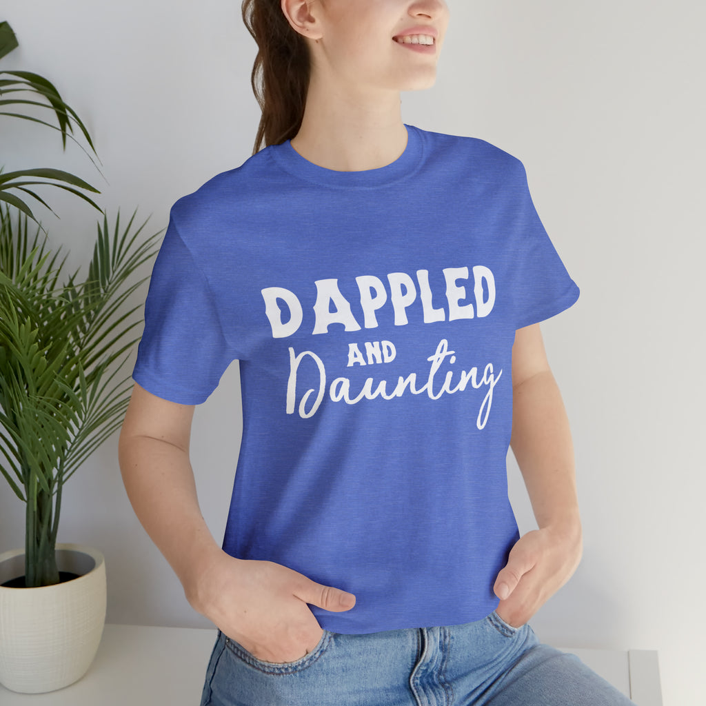 Blue short sleeve with white lettering reading "Dappled and Daunting". 