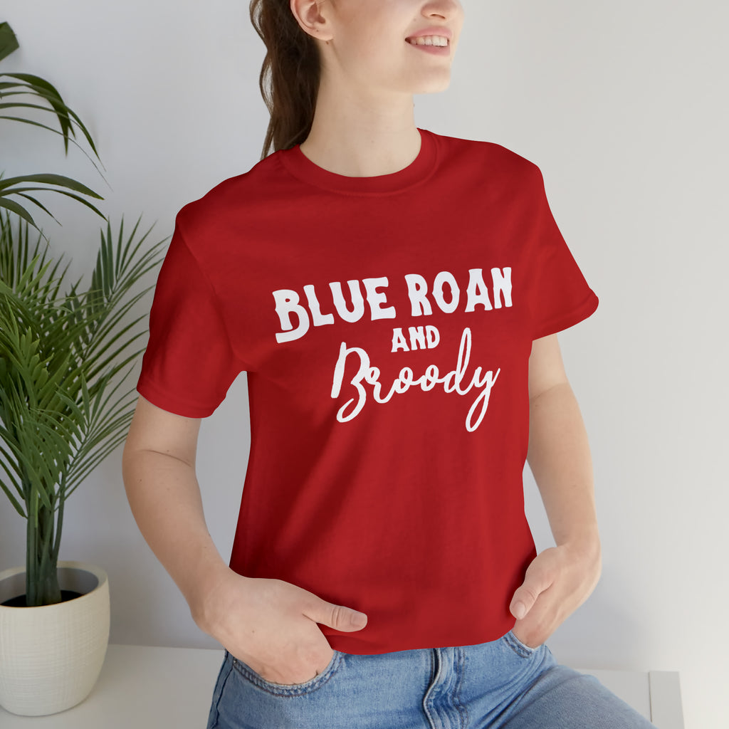 Red short sleeve with white lettering reading "Blue Roan and Broody". 