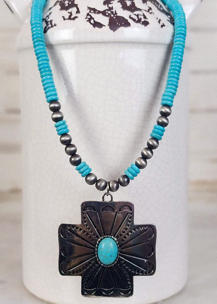 Silver cross pendant with turquoise stone