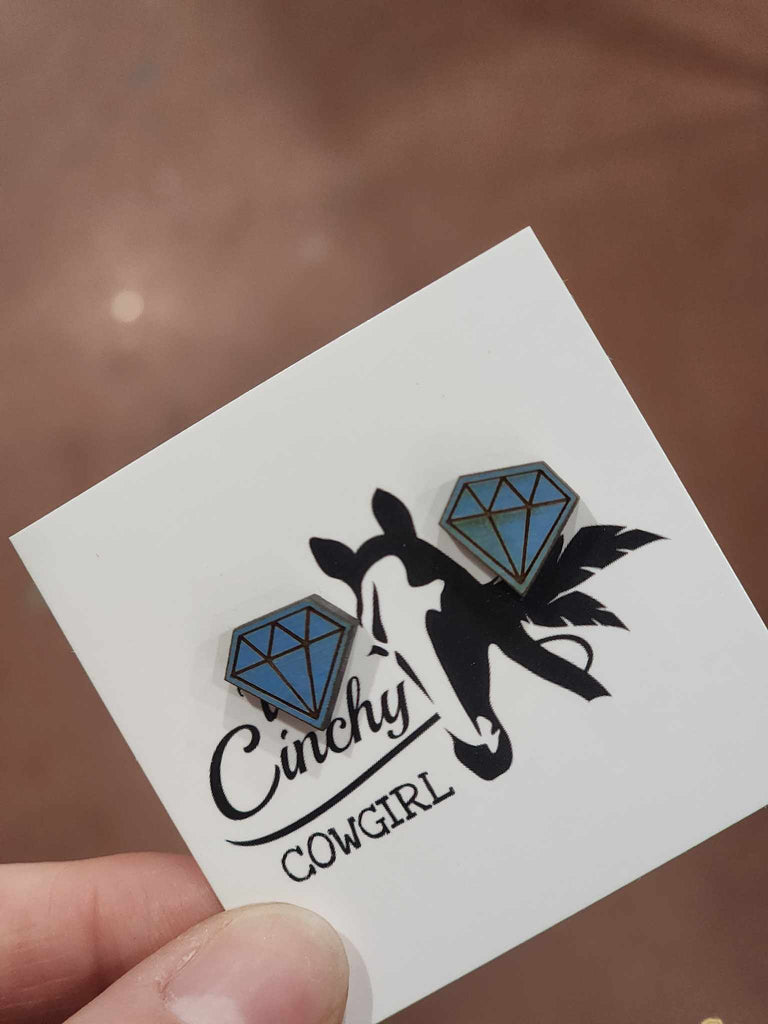 Blue wooden diamond stud earrings one white TCC cardstock. 