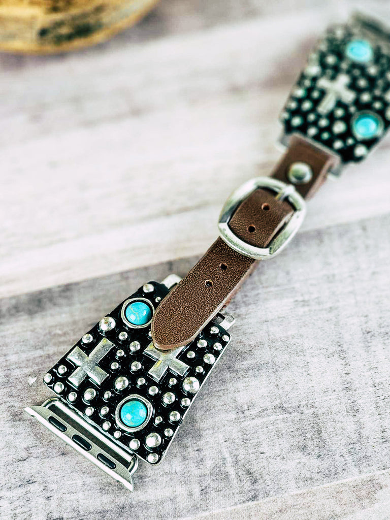 Cowgirl watch band with antique silver cross design and turquoise like stones. Leather band with punched holes and silver buckle.