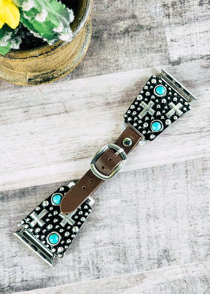Cowgirl watch band with antique silver cross design and turquoise like stones. Leather band with punched holes and silver buckle. 