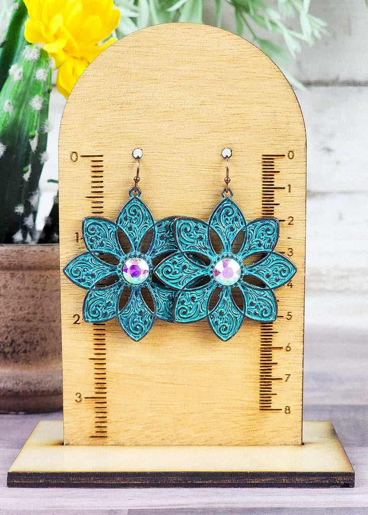 Cowgirl antique silver with teal inlay floral earrings with jewel stone that changes color in different lighting.  Hangs about 2.25" on measuring block.