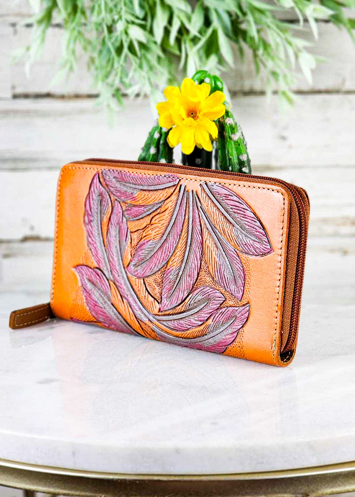 Bright Cowgirl wallet with zipper across the top. Feather tooling design.