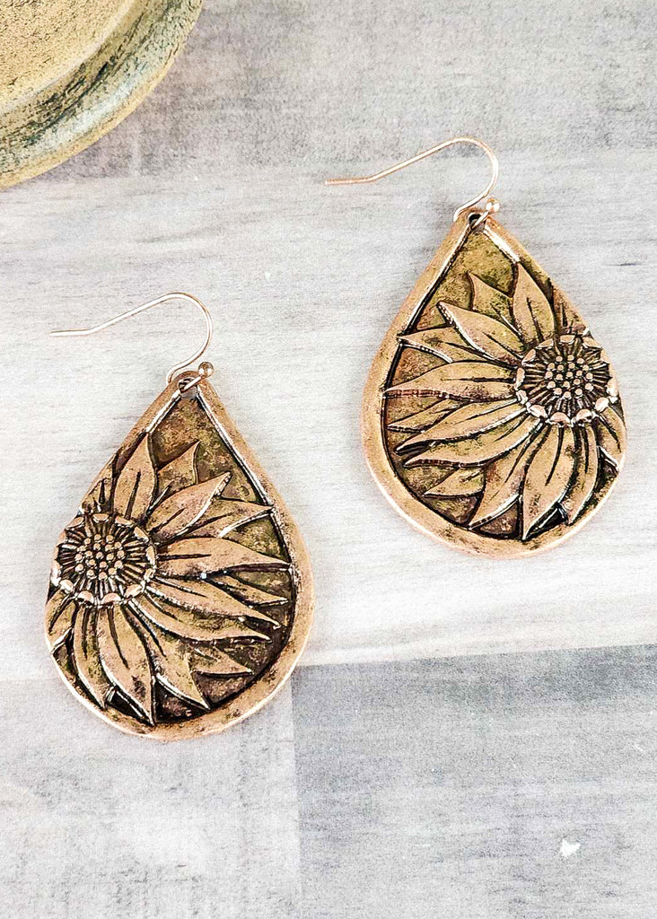 Burnish copper western earrings with engraved sunflower design. 