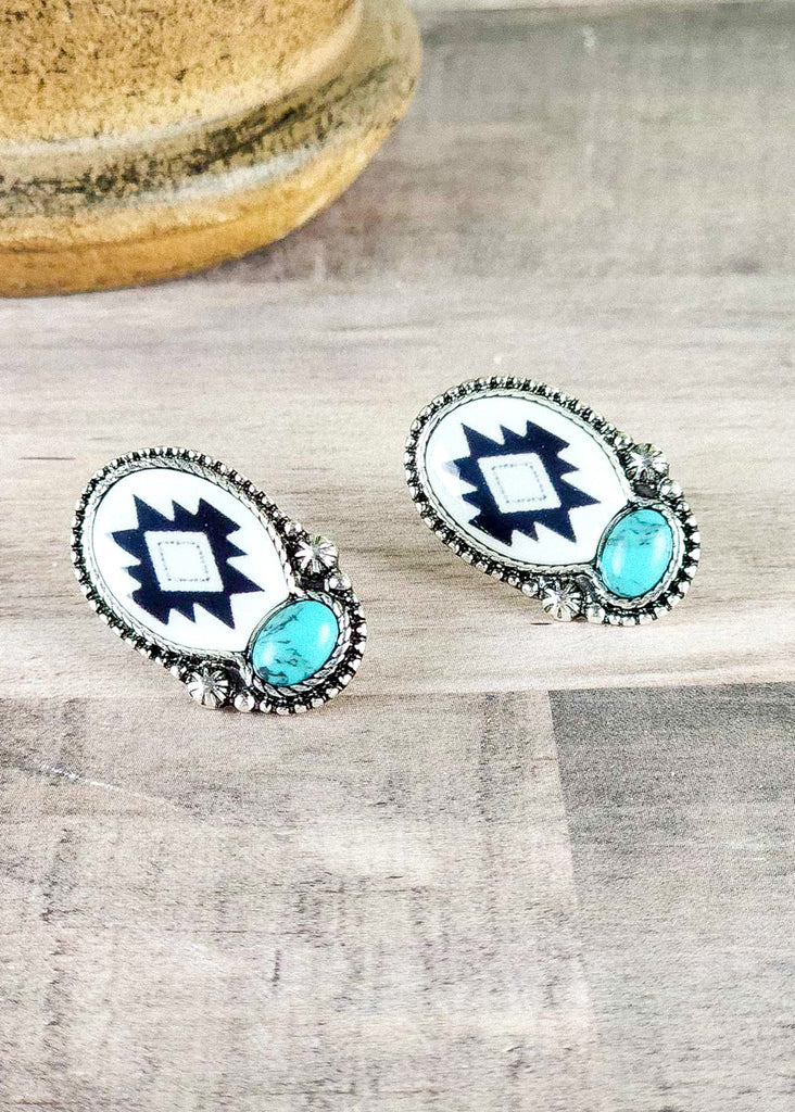 Southwestern stud earring with an aztec design epoxied in and encased by antique silver. Turquoise like stone set in antique silver. 
