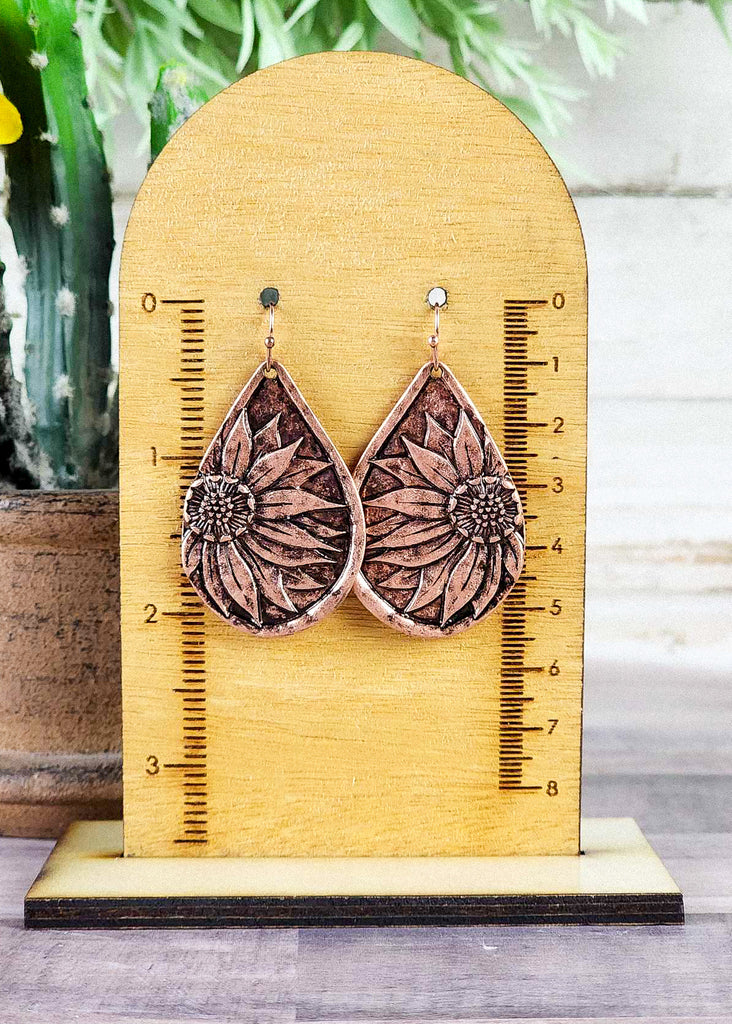 Burnish copper western earrings with engraved sunflower design. About 2" long.