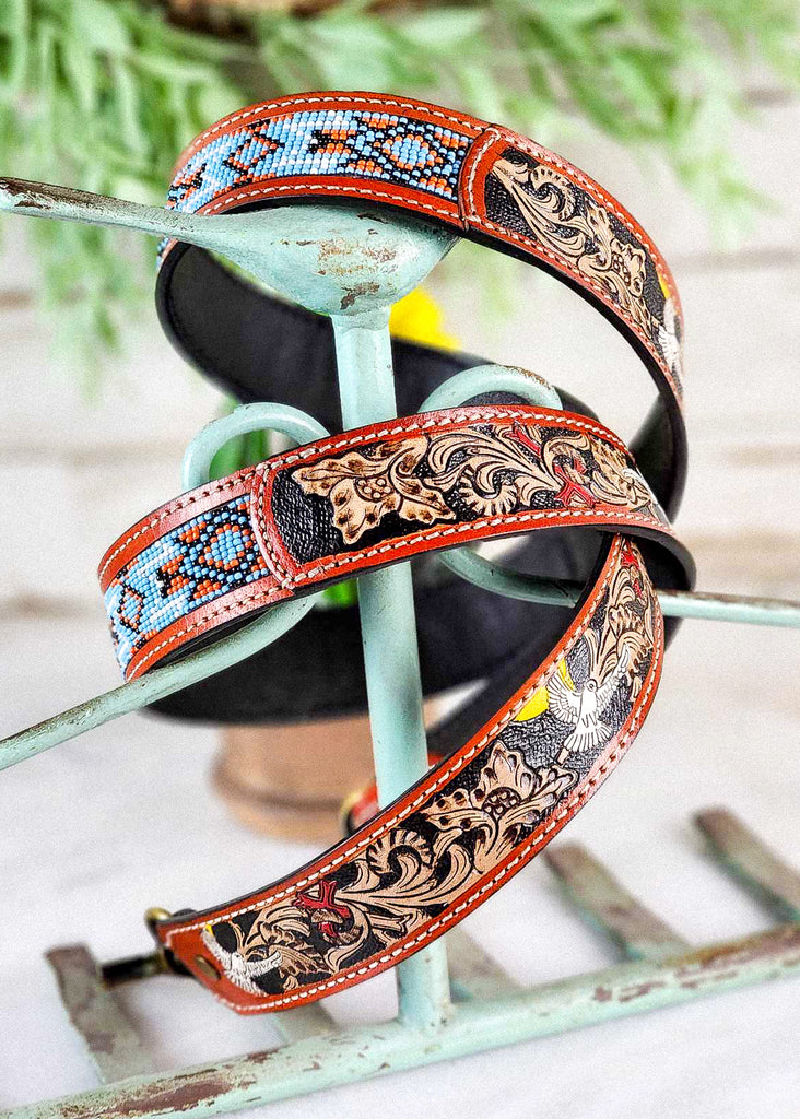 Coiled southwestern strap with beautiful hand tooling. The floral tooling holds crosses and doves. 