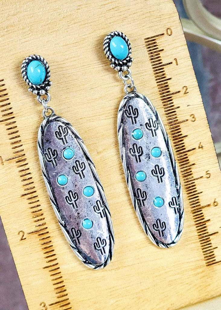 Southwestern cowgirl earrings with turquoise like stones for the stud and on the antique silver with stamped cactus and twisted design. 