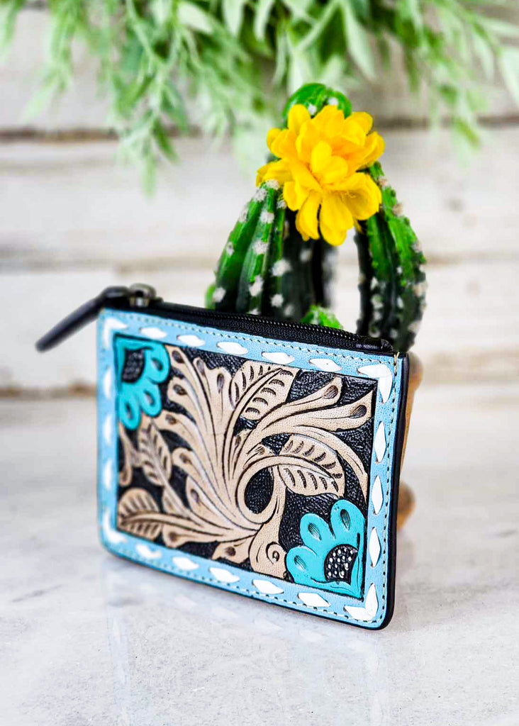 Cowgirl card holder with blue accents and floral tooling. Zipped pocket at top. 