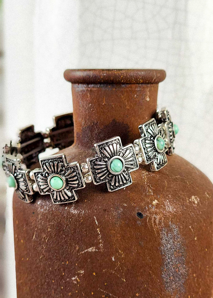 Cowgirl western cross bracelet with turquoise like stone. 