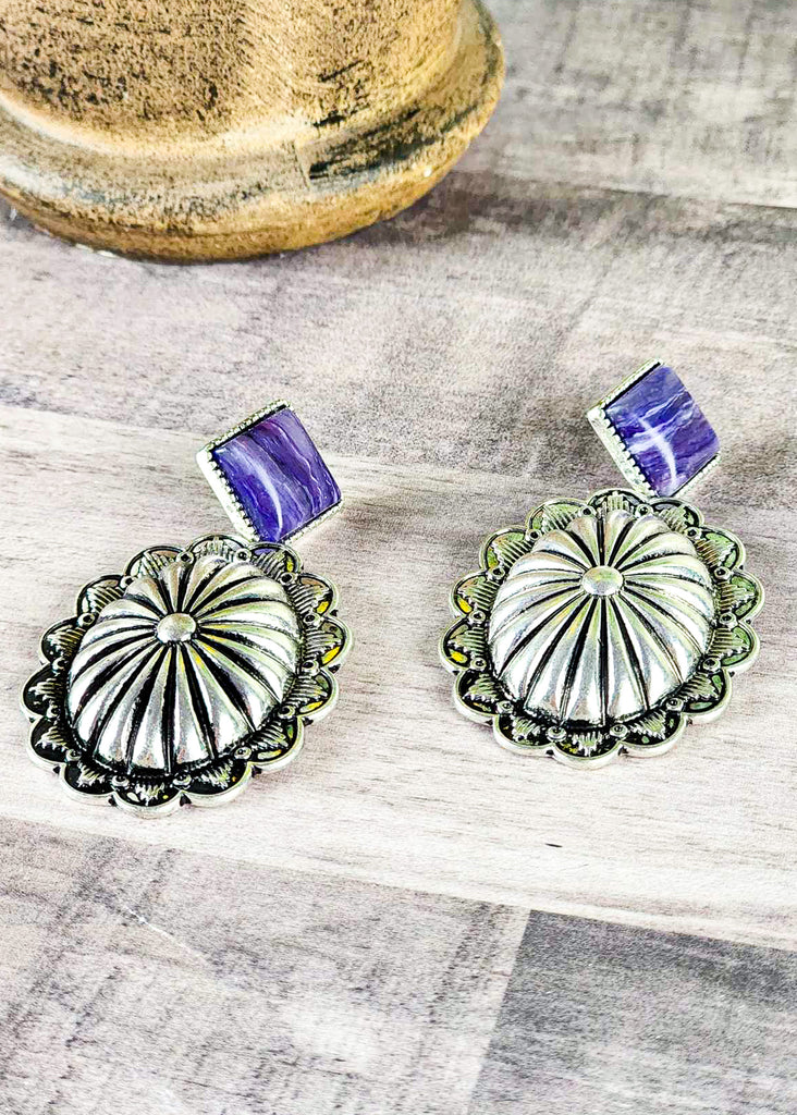 Cowgirl concho earring showing purple studded stone showing the unique coloring differences in stone. 