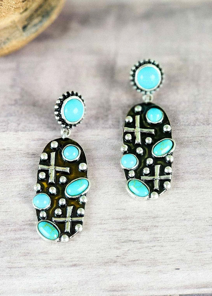 Cowgirl faith earrings with turquoise-like stone and antique silver with cross design.