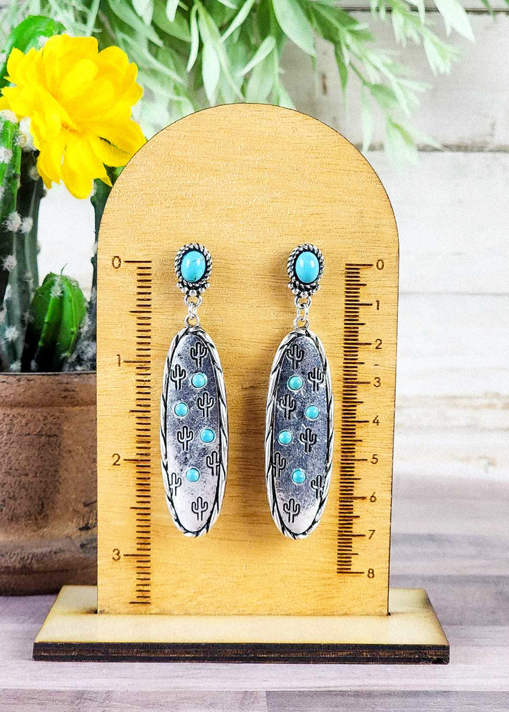 Southwestern cowgirl earrings with turquoise like stones for the stud and on the antique silver with stamped cactus and twisted design. 