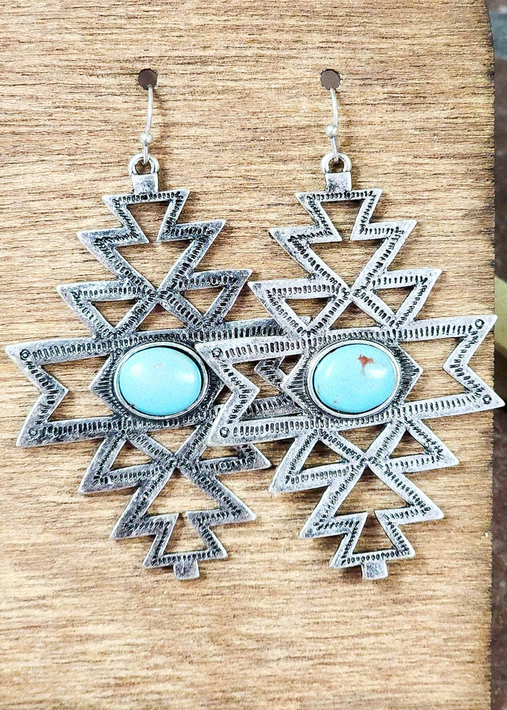 Cowgirl western dangle earrings with an aztec antique silver cut out and a turquoise like stone. 