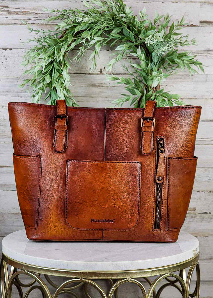Western conceal carry handbag with brown genuine leather. Zippered concealed carry pocket visible with open back and side pockets. 