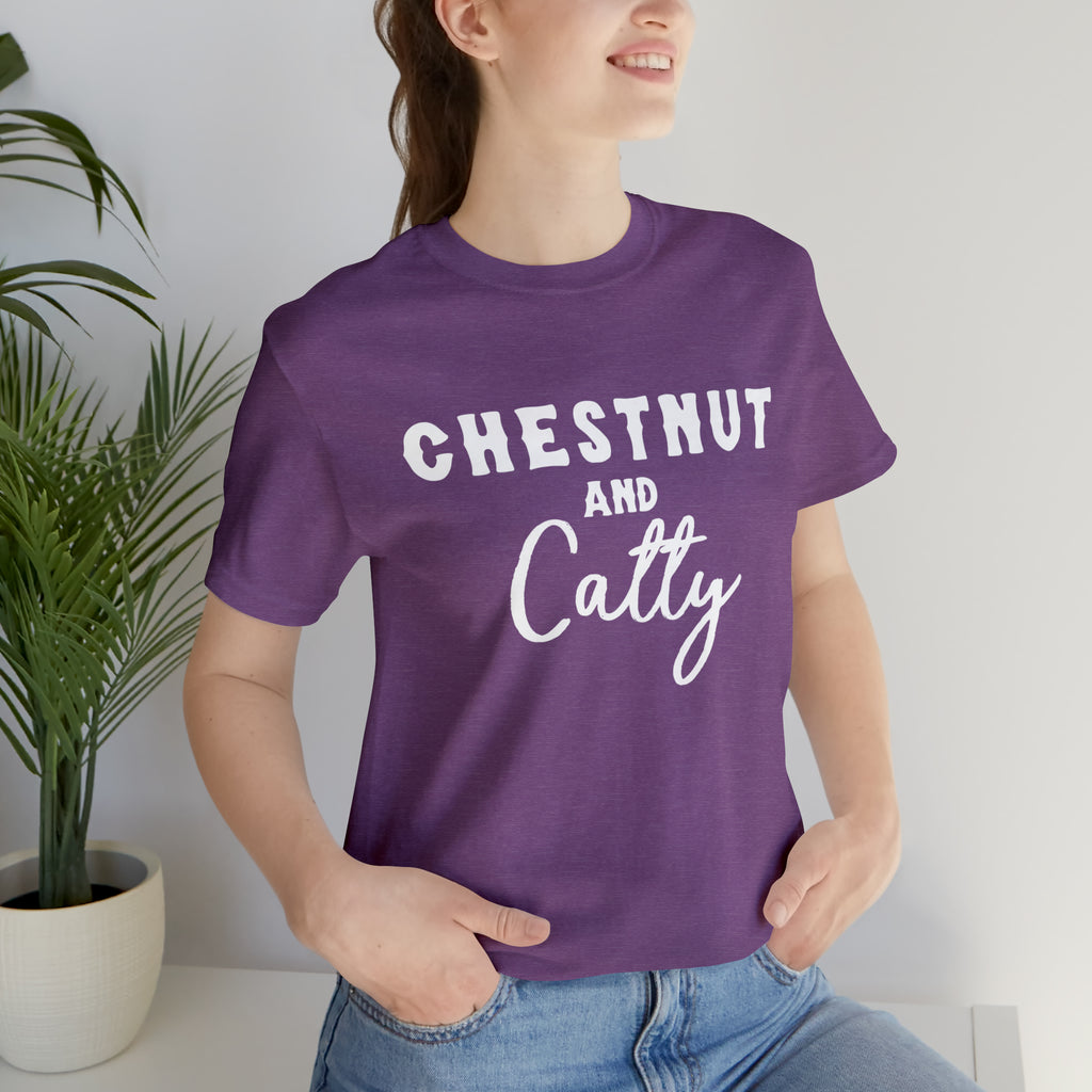 Purple short sleeve with white lettering reading "Chestnut and Catty". 