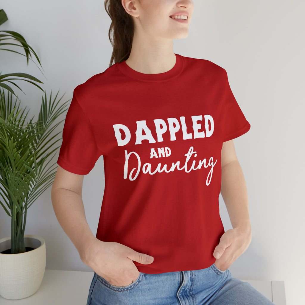 Red short sleeve with white lettering reading "Dappled and Daunting". 