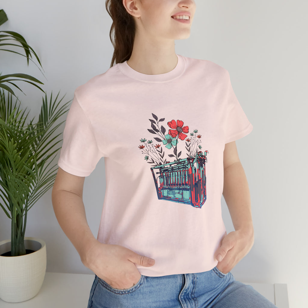 Soft pink short sleeve with flower teal and pink chute in the middle of the tank. 