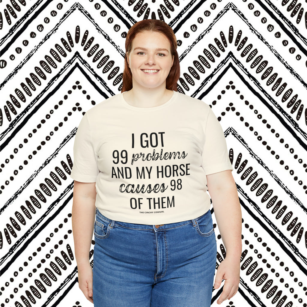  natural short sleeve with black lettering reading "I got 99 problems and my horse causes 98 of them".