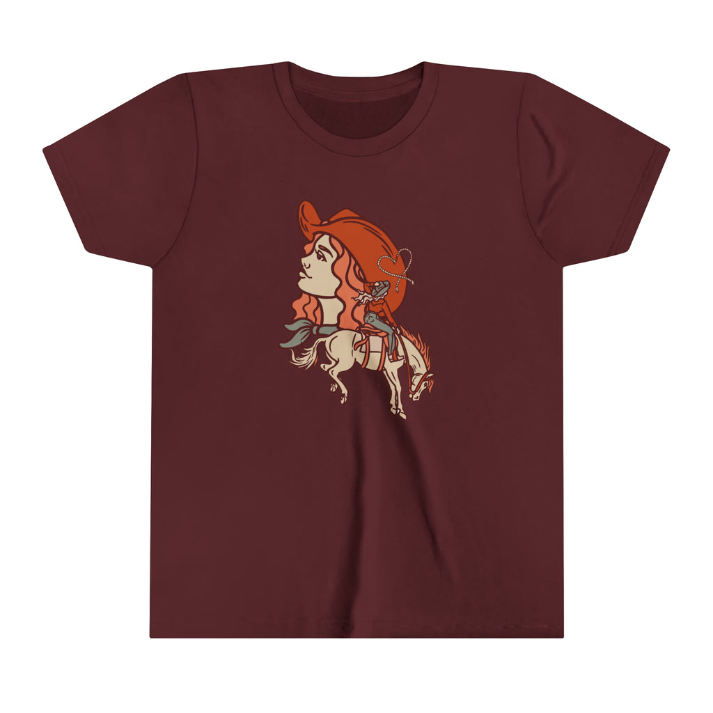Maroon youth short sleeve with a cowgirl printed design and bronc horse with a cowgirl showing a cowgirl's personality. 