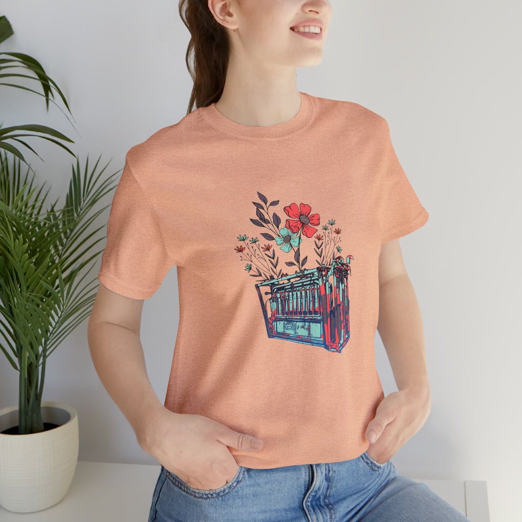 Peach short sleeve with flower teal and pink chute in the middle of the tank. 