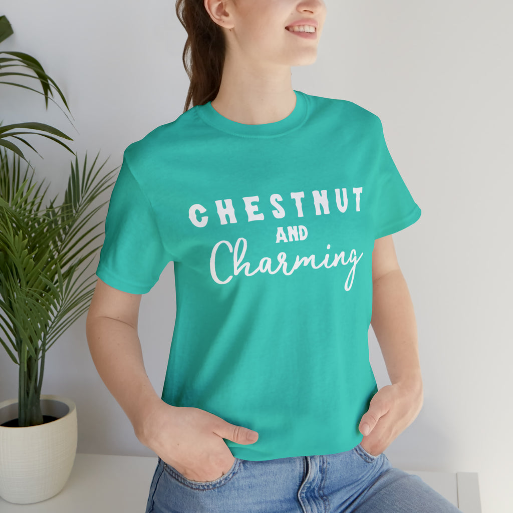 Teal short sleeve with white lettering reading "Chestnut and Charming". 