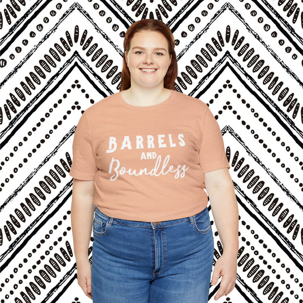Peach plus size short sleeve with white lettering reading "Barrels and Boundless".
