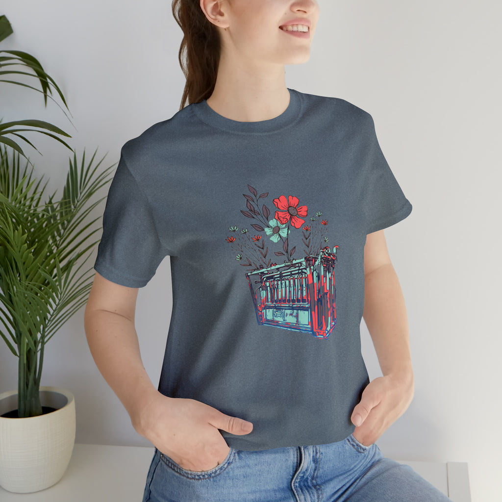 grey short sleeve with flower teal and pink chute in the middle of the tank. 