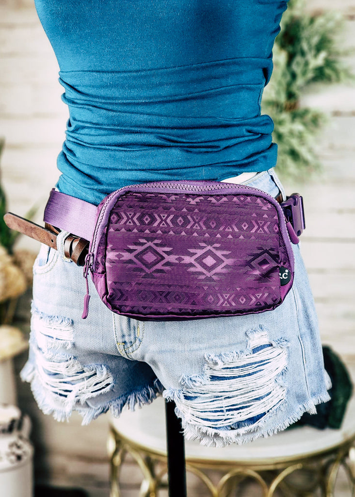 Purple Aztec embossed fanny pack. Top zipper visible on waist of mannequin. 