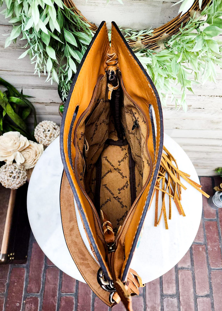 Zipper closing the top of the purse. Interior with multi pockets and a zippered pocket.