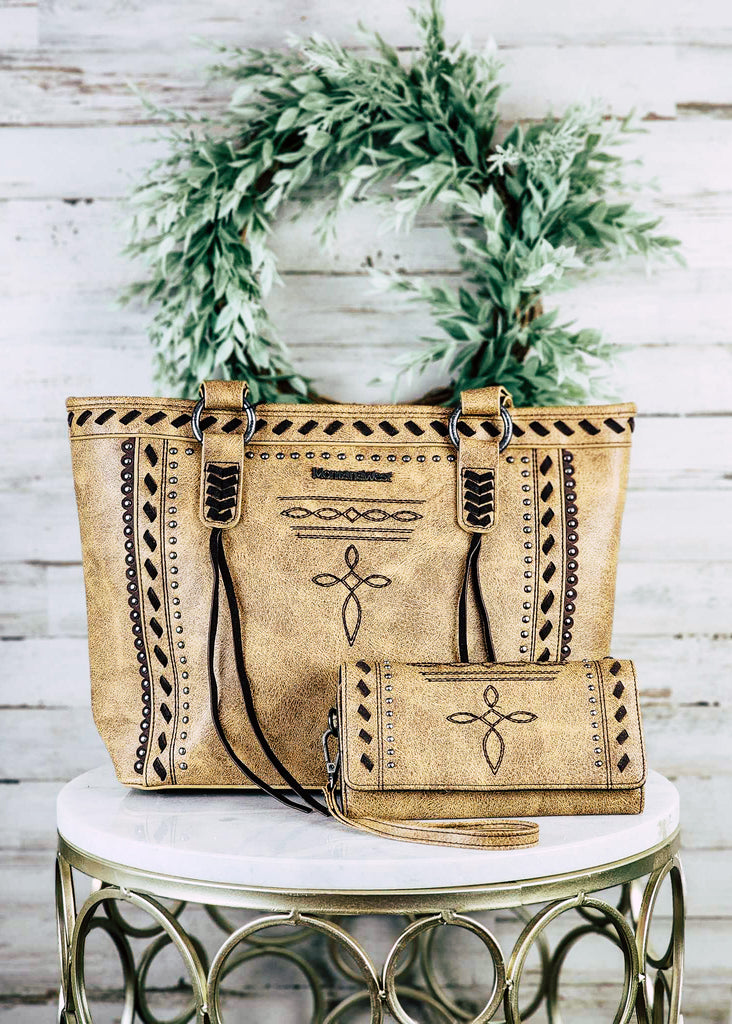 Concealed carry tote and wallet set with cross embroidered design. Silver studs line the design in a square. Angled whip stitch in centered between the studs and top of the purse. 