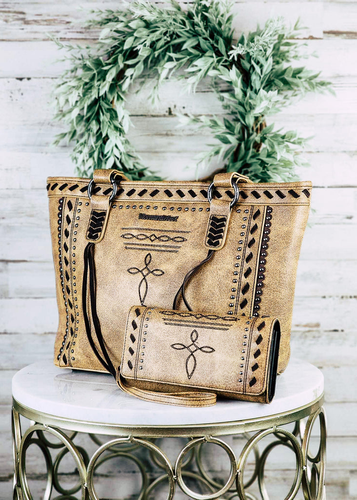 Concealed carry tote and wallet set with cross embroidered design. Silver studs line the design in a square. Angled whip stitch in centered between the studs and top of the purse.