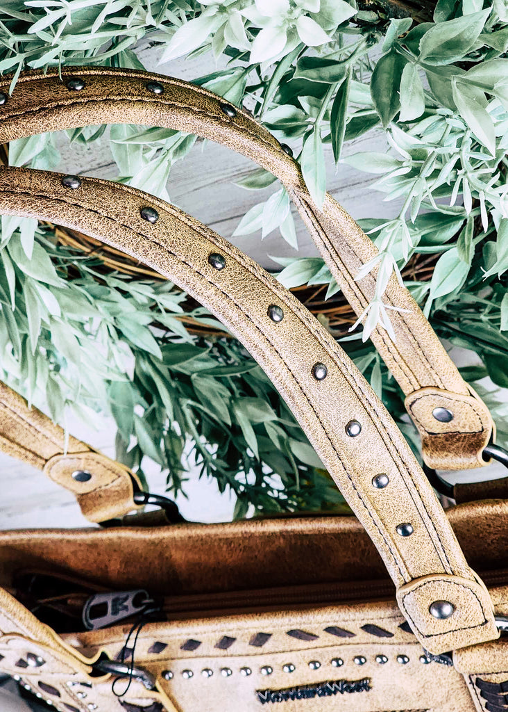 Concealed carry handbag strap with silver studs lining the center. 