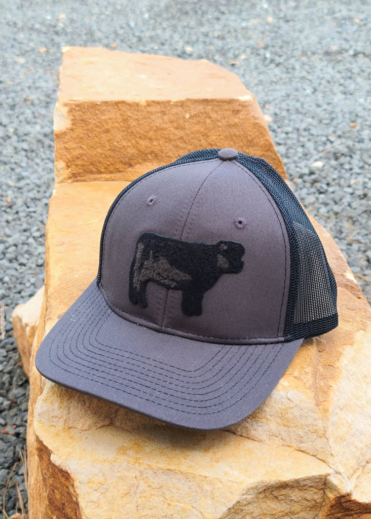 Cow Patch Dark Grey And Black Trucker Hat patch trucker hat The Cinchy Cowgirl
