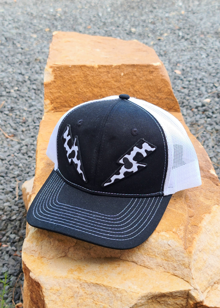 Cow Print Lightning Bolt Patches Black And White Trucker Hat patch trucker hat The Cinchy Cowgirl
