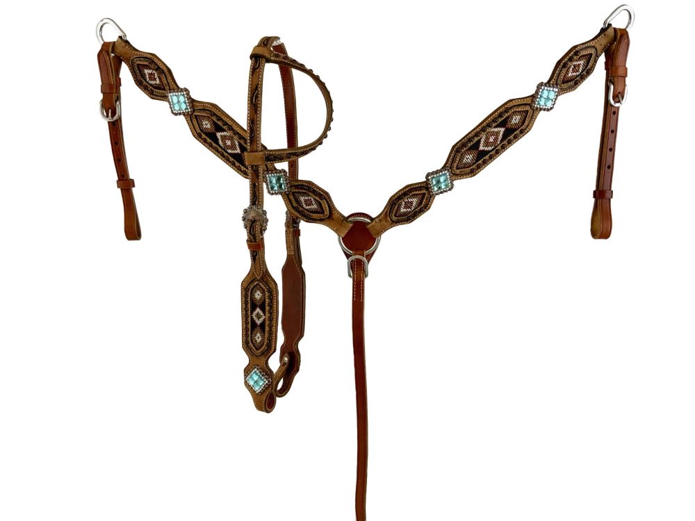 Western one ear headstall with black, gold, and red tribal beading designs. Turquoise stone conchos on breast collar and headstall. Silver studs decorate the one ear piece and antique concho buckle lays on the cheek. 