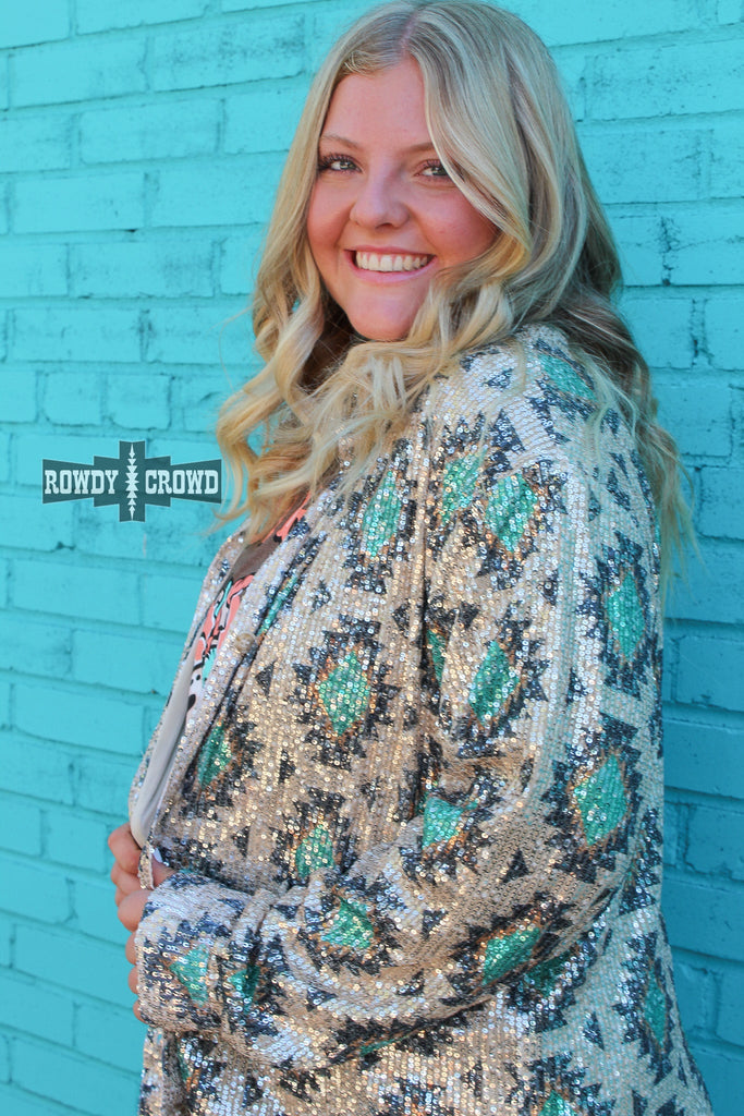 Southwestern bling button up with tribal designs and sparkle. Model is angled showing off the side of the button up and its natural shine. 