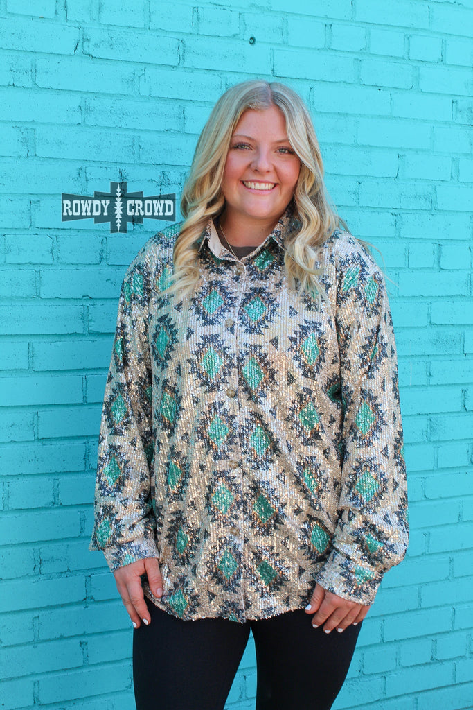 Southwestern bling button up with tribal designs and sparkle. Model is wearing buttoned with black leggings against a turquoise wall. 