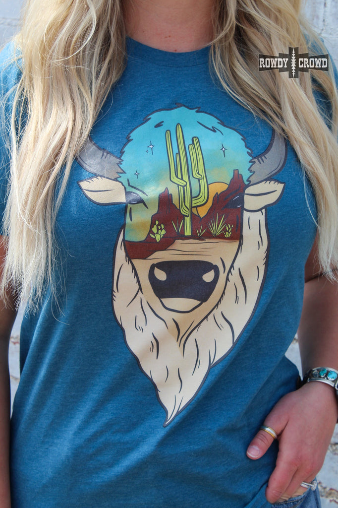 Teal short sleeve tee with a printed buffalo design with a desert scenery on the face. Shirt is zoomed in on model. 