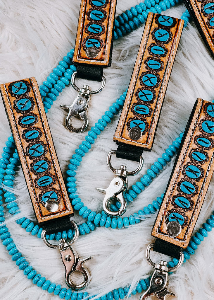 Leather Turquoise Stone Tooled Keyring on white rug with turquoise beads