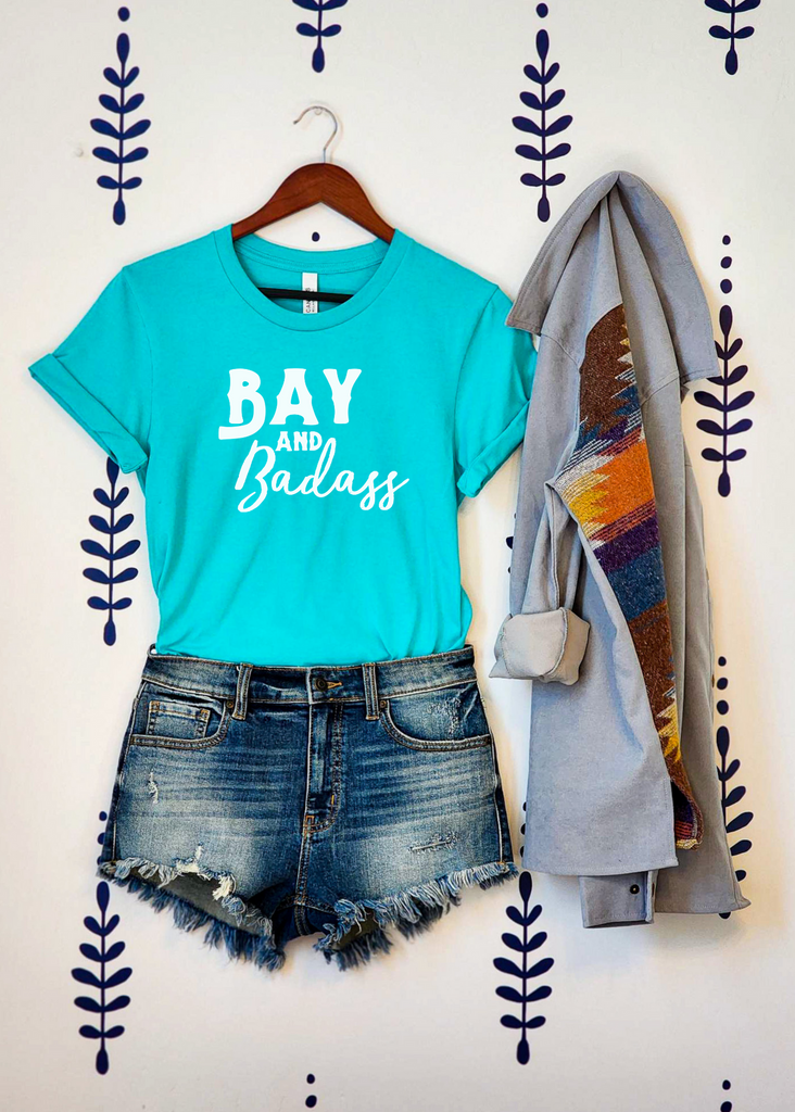 Teal short sleeve with white lettering reading "Bay and Badass".
