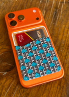 aztec spade card holder on orange phone with wood background
