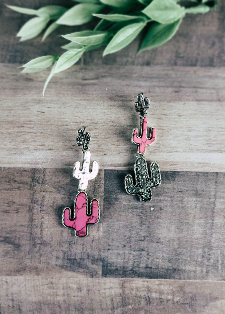 Pink and Silver Cactus Earrings on wood background with green decor